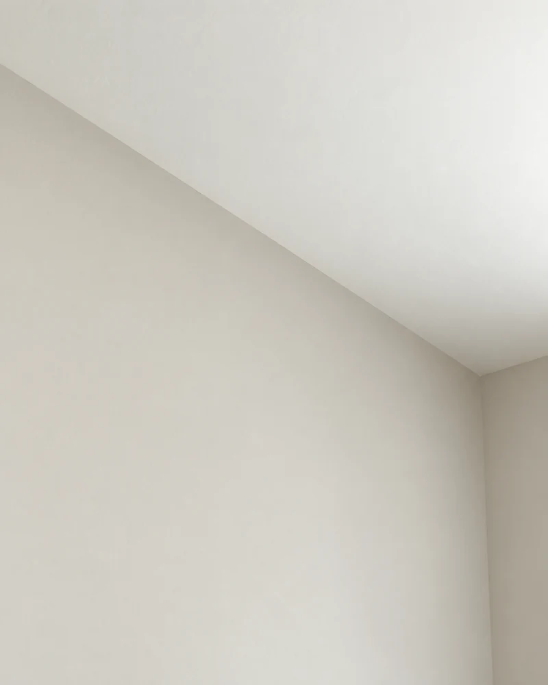 Illustrative clean junction between a smooth wall and ceiling